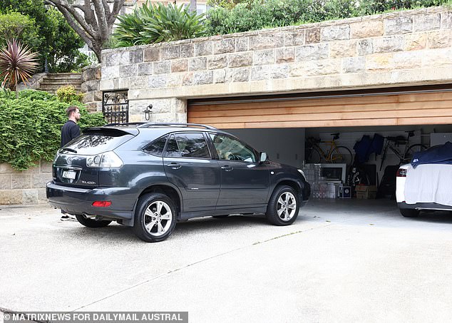 Mrs Bayer Rosmarin's husband, Rodney, is seen behind the wheel of their silver Lexus, while a white Tesla is also seen in their three-car garage