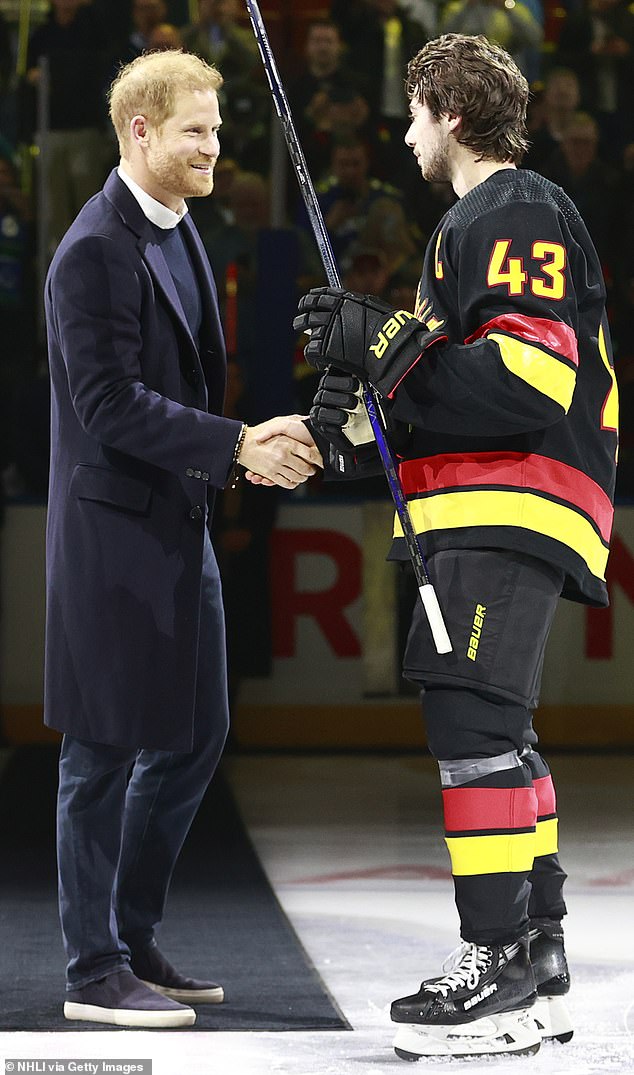 Regards!  Prince Harry shakes hands with the Canucks' Quinn Hughes during the outing in Vancouver