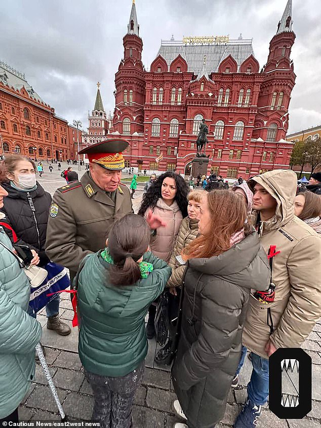 An officer speaks to women in Moscow protesting the mobilization of young men in Putin's war