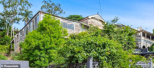 The house at 49 Deighton Road (pictured) is just over ten minutes away from the Brisbane CBD and also within walking distance of The Gabba