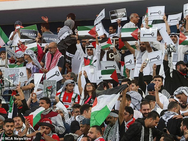 Supporters wave Palestinian flags ahead of the 2026 AFC FIFA World Cup football match between Palestine and Australia.  (Photo by Yasser Al-Zayyat / AFP)