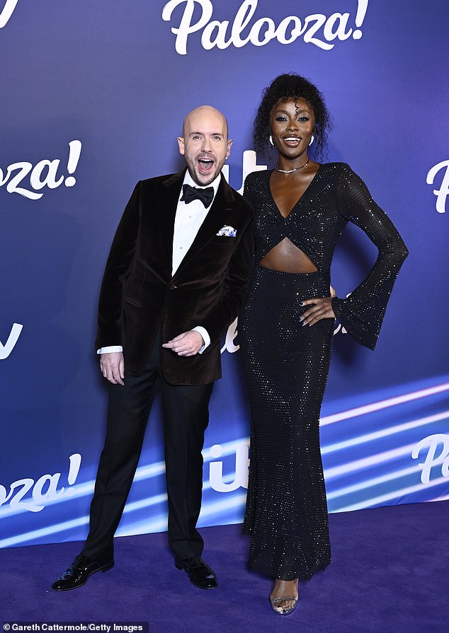 Pals: The star looked in good spirits as she posed alongside comedian Tom Allen, who looked dapper in a black suit