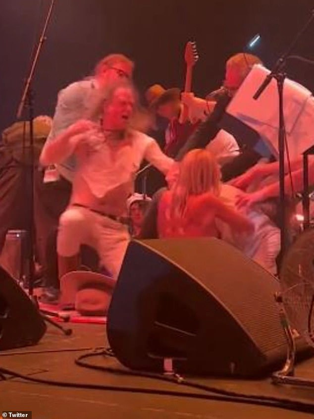 Fans watched in horror as two rockers exchanged punches on stage at The Forum before slamming each other to the ground