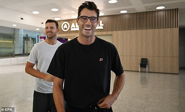 Pat Cummins left a horde of journalists in stitches at Sydney Airport after arriving from India on Wednesday morning (pictured) thanks to a cheeky one-liner about his body odor