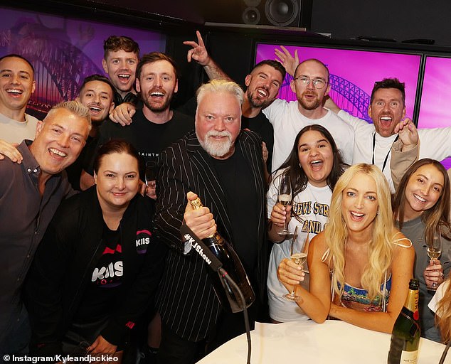 An excited Kyle popped open a $100 bottle of Moët & Chandon champagne at their KIIS FM studios in Sydney to toast the news with Jackie and their hard-working team