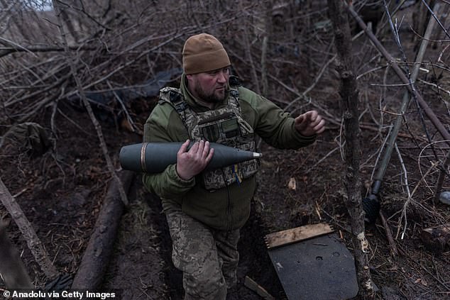 A Ukrainian soldier carries a grenade in his fighting position towards Bakhmut, Ukraine, on November 18