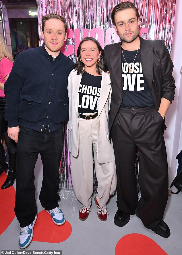 Also present at the Choose Love pop-up shop event were actors Douglas Booth (R) and Bel Powley, both wearing the charity's Choose Love T-shirt (also joined by actor Joe Cole L).