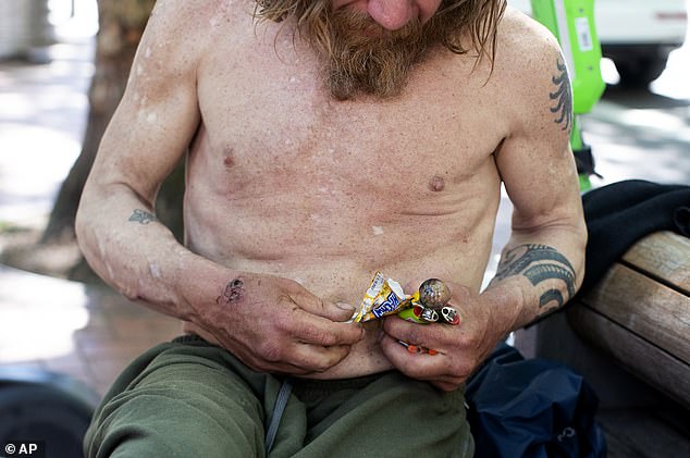 Three years after Oregon voted to decriminalize drug crimes, residents are now begging for their decision to be reversed after seeing a staggering number of deaths from opioid overdoses (Photo: A man holding a glass pipe in Portland)