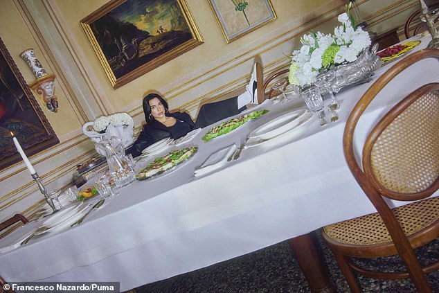 Edgy: The photoshoot took place in an Italian villa, where she posed on a lavish table set up for a dinner party