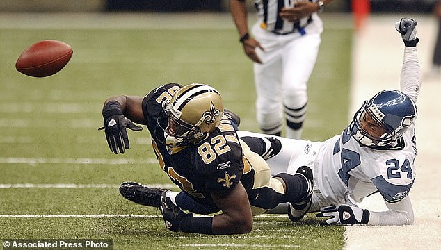 Williams (with 82) has the ball knocked loose from his grasp by Seahawks' Bobby Taylor