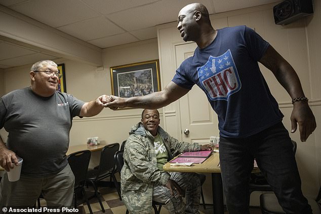 Williams fist bumps a fan, Frank Lossett, left, who recognized the former New Orleans Saints player while having lunch at Two Sisters Creole Kitchen in Picayune, Miss., earlier this month