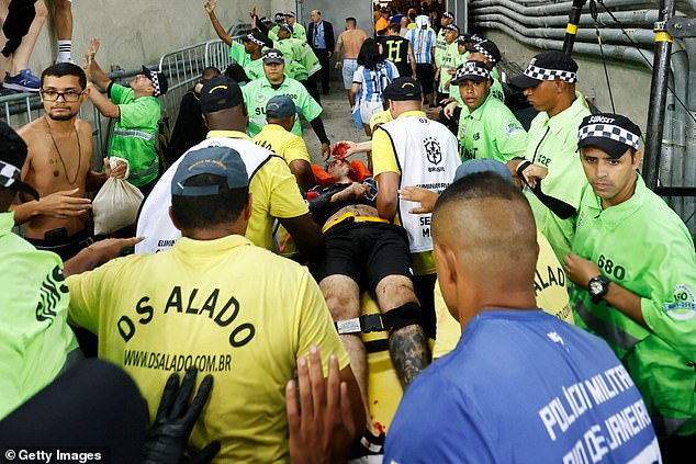 One fan, Eugenio, was taken away on a stretcher after suffering a head injury before kick-off