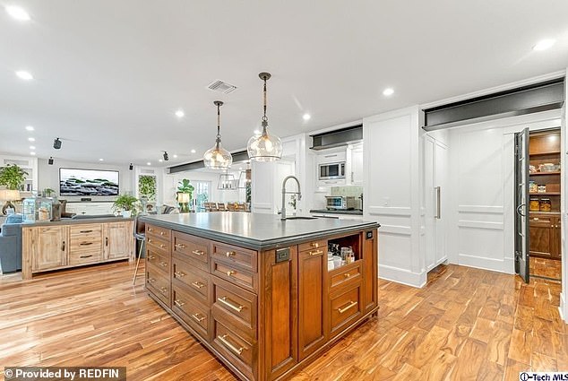 The property features more than six bedrooms and bathrooms, a 'butler's pantry' in the kitchen (pictured), as well as multiple fireplaces and a 'mud room'.