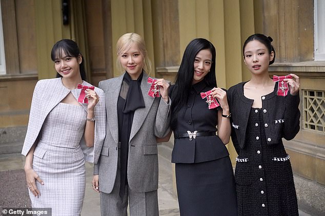 The members of BLACKPINK pose with their honorary MBEs awarded to them in recognition of the band's role as advocates for COP26 ahead of the 2021 COP26 Glasgow Summit