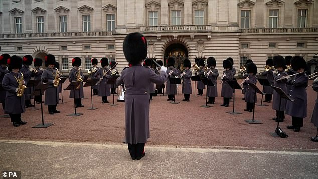 Footage shows the Coldstream Guards performing upbeat pop hits on the forecourts of Buckingham Palace during the state visit