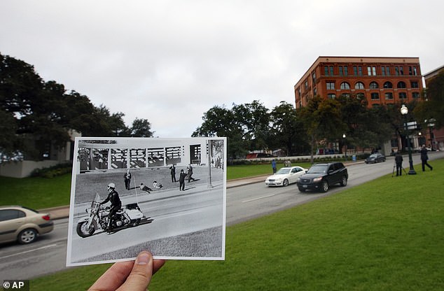 A photo taken by Dallas Morning News photographer Tom Dillard on November 22, 1963, of spectators lying on the ground in Dealey Plaza as a motorcycle officer drives by immediately after the shooting