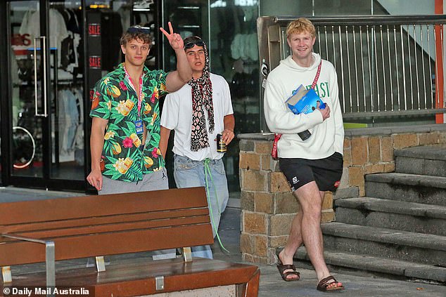More than 20,000 teenagers will converge on the Gold Coast to toast the end of school, with festivities officially kicking off last weekend.  (Three young men are pictured during Schoolies Week; it is not suggested that they take part in the filming of adult content)