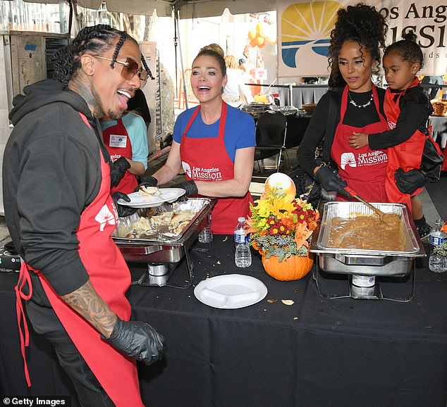 Family affair: He was joined at the event by his beauty queen, baby mama Brittany Bell, who cradled their two-year-old daughter Powerful Queen