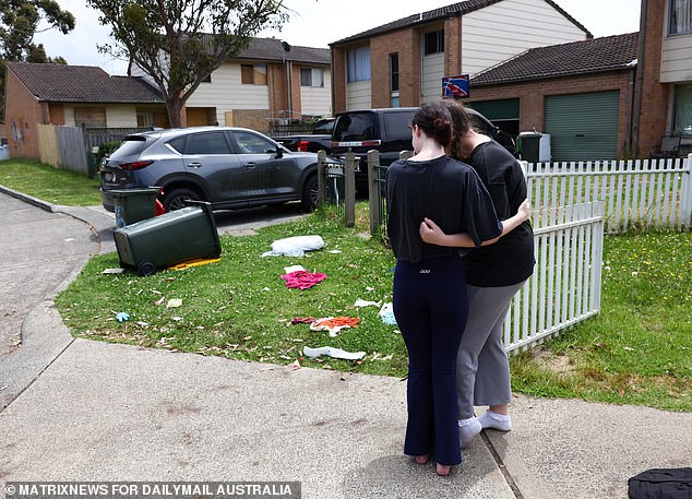 A family member (pictured at the scene with a relative) said the attack was sparked by an alleged cyberbullying incident