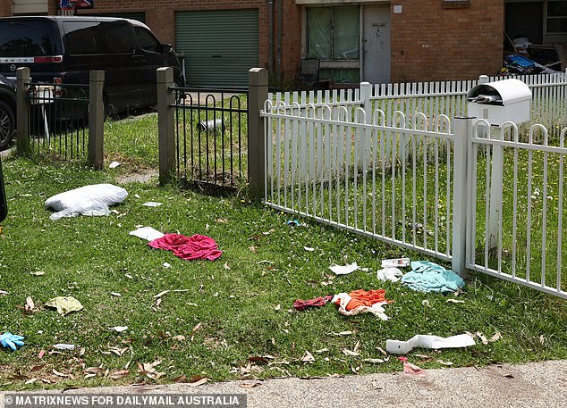 Blood-stained clothing (pictured) was strewn across the driveway after towels and clothing were used to stop Ms McBride's bleeding