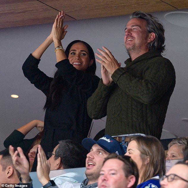 The couple - who are exploring the western city in Canada this week - grinned with the delighted duo, who bumped into the royals during lunch.  Meghan pictured at an NHL game this week