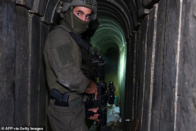 A soldier stands in what the Israeli army says is a tunnel dug by Hamas militants on Wednesday in the Al-Shifa hospital complex in Gaza City in the northern Gaza Strip.