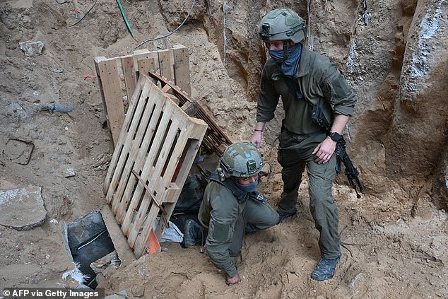 An Israeli soldier climbs out of a tunnel that the army says was dug by Hamas militants in the Al-Shifa hospital complex in Gaza City in the northern Gaza Strip on Wednesday.