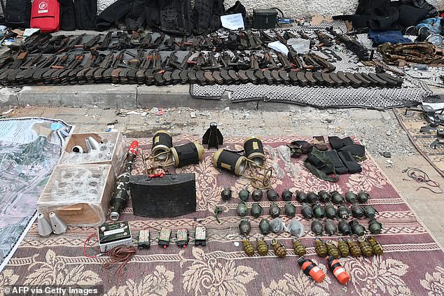 Weapons that the Israeli army says were left by Hamas militants at Al-Shifa hospital are on display at the medical complex in Gaza City on Wednesday