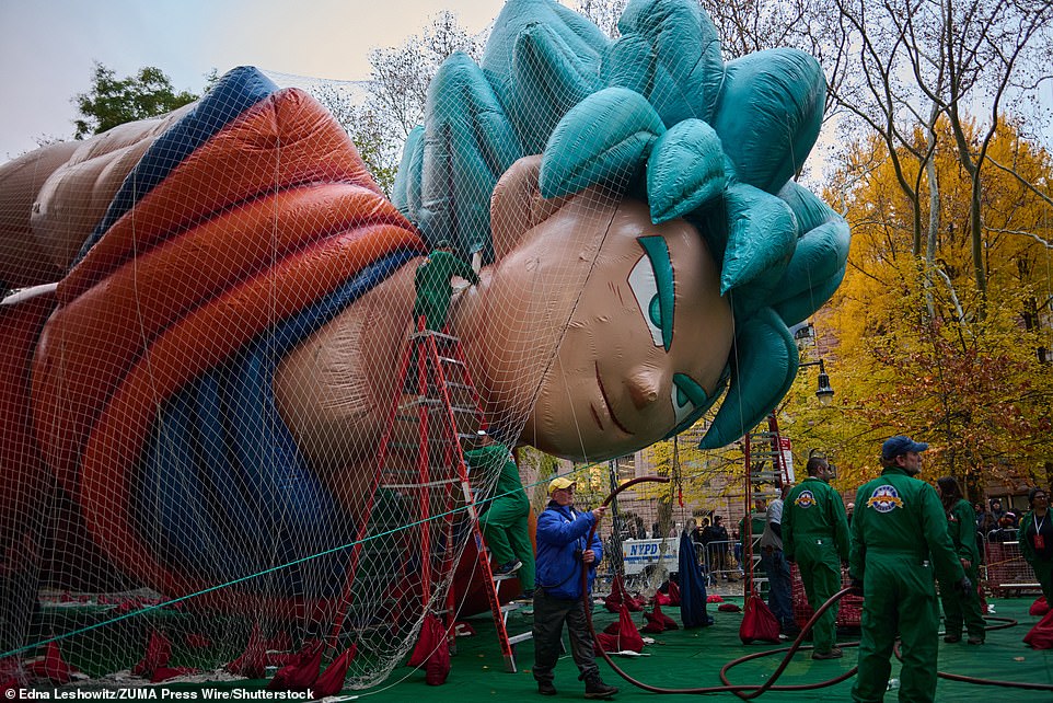 Workers are seen inflating a huge Goku balloon near Central Park as the city prepared for Wednesday night's parade