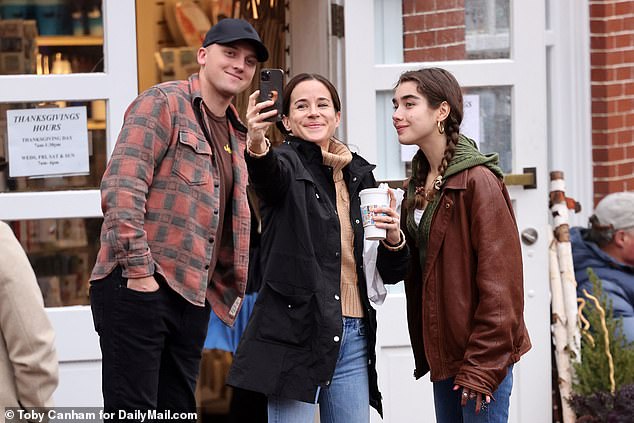 First daughter Ashley Biden (center) holds up her phone to take a selfie with Peter Neal (left), the husband of her niece Naomi Biden and niece Natalie Biden (right)