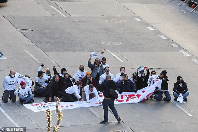 Pro-Palestinian protesters jumped the barricade and brought the parade to a halt Thursday morning about two hours after the procession got underway.