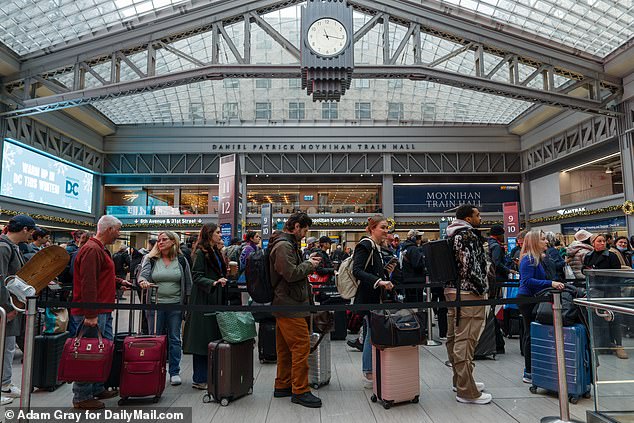 People travel through the Moynihan Train Hall at Pennsylvania Station in Manhattan before Thanksgiving