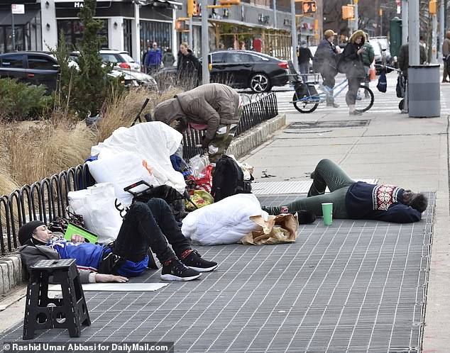 Homeless people are seen on 1st Avenue between 20 and 21st streets in Manhattan, New York