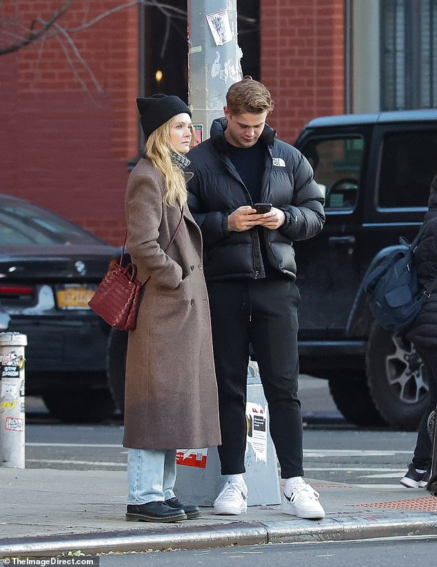 Meghann stays warm: She stayed warm with a black stocking cap and a red leather bag over her shoulder