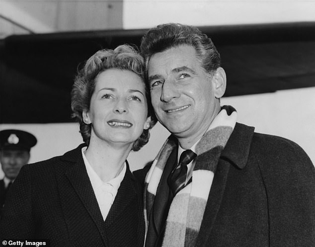 American composer Leonard Bernstein arrives at London Airport with his wife, actress Felicia Montealegre, on October 9, 1959