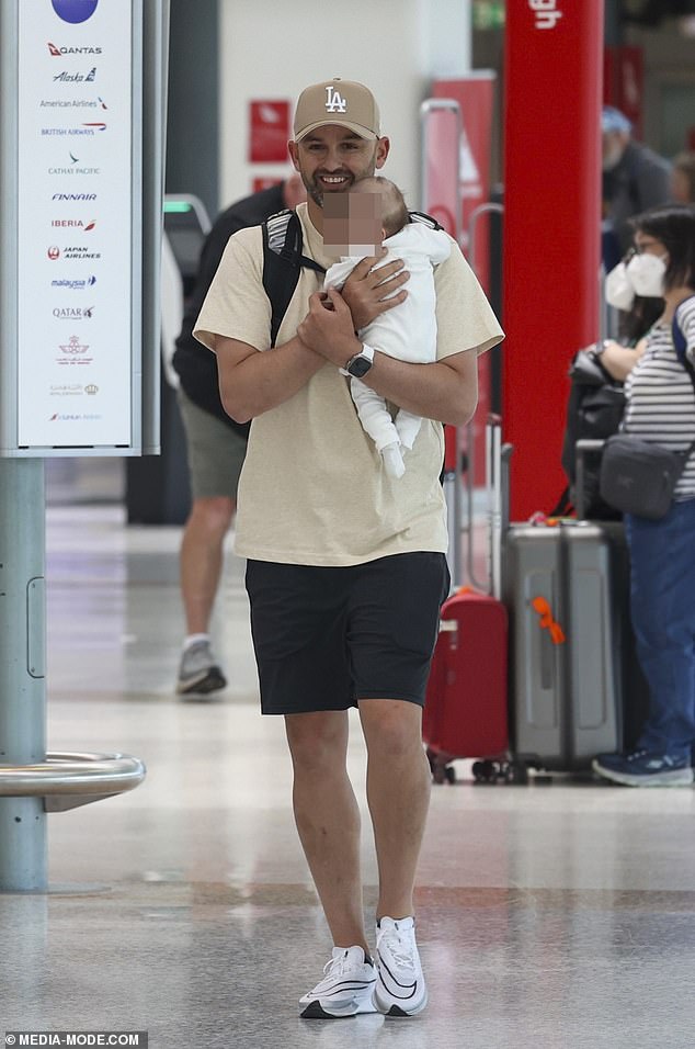 Nathan Lyon is now a proud father, pictured at Sydney airport on his way to Western Australia