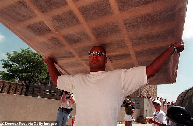 Hasselbach carries a box spring into a dorm room upon arriving at Broncos training camp in 1998