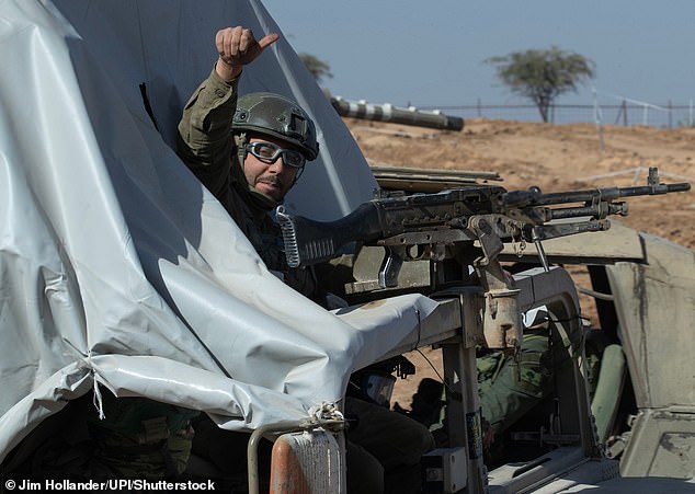 An Israeli soldier is seen leaving the Gaza Strip and returning to his base on Thursday.  The ceasefire was scheduled to take effect at 7 a.m. local time on Friday