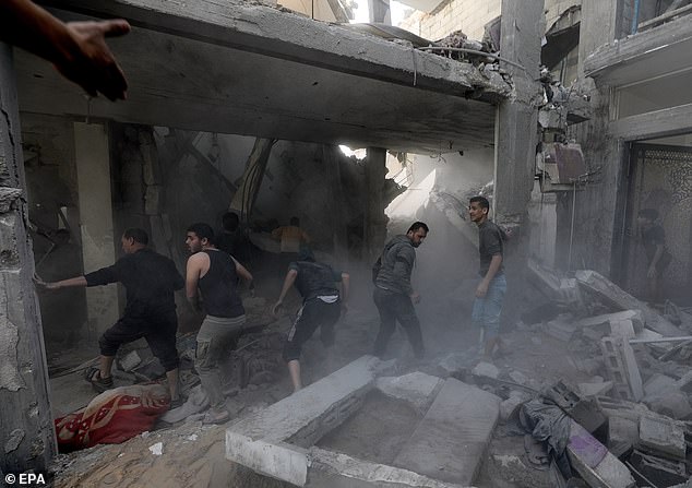 Palestinians search for bodies and survivors among the rubble of a destroyed house on Thursday after new Israeli airstrikes in Khan Younis, southern Gaza