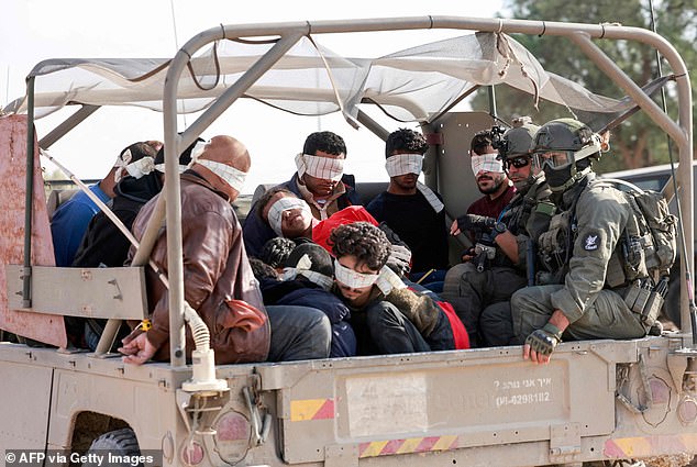 On November 21, Israeli soldiers are seen transferring detained Palestinians from the Gaza Strip