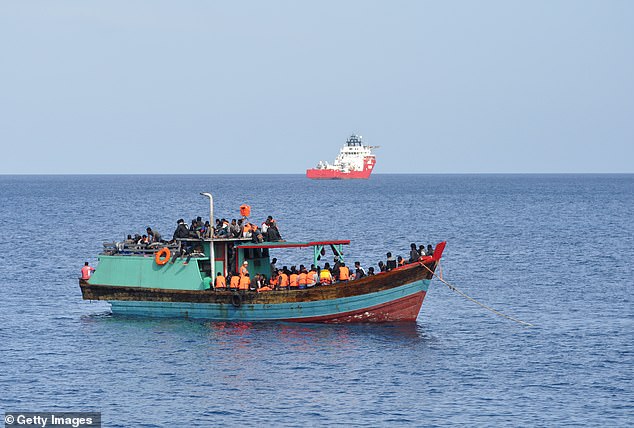 A mysterious ship with 12 foreigners on board was found in remote crocodile-infested waters off the coast of northern Western Australia on Wednesday (pictured, suspected asylum seekers arrive on Christmas Island in 2012)