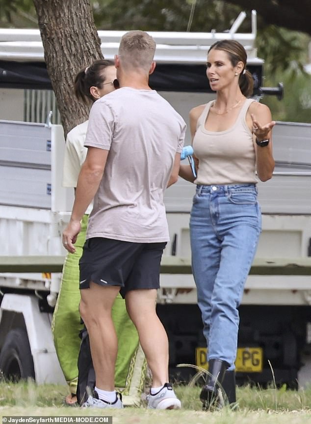 Candice, 38, showed off her toned figure in a form-fitting beige designer tank top which she paired with jeans and black boots.  Meanwhile, her cricket star husband David, 37, color-coordinated with his wife in a beige T-shirt, black Nike shorts and sneakers