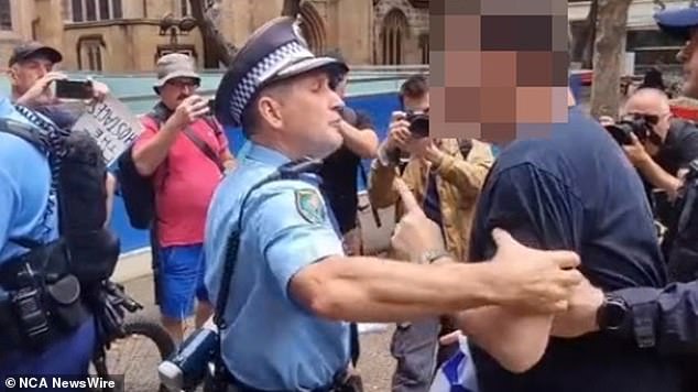 The man was led away from the protest in Sydney to avoid a 'breach of the peace'
