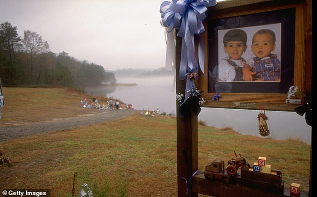 Mourners visit a shrine near the lake where Michael, 3, and Alexander, 14 months, were murdered.  The boys were strapped into their car seats when the vehicle fell into the water and sank