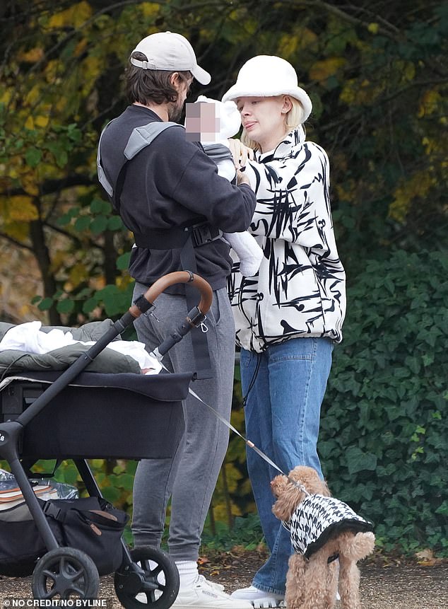 Family time: The trio appeared to have a lovely day out as they cooed over their newborn while accompanied by their pet