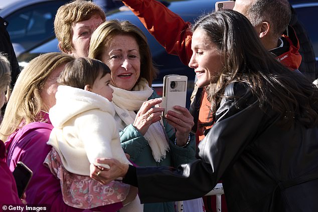 The adored royal was pictured chatting to fans and taking pictures with them, beaming as she chatted with a mother and baby