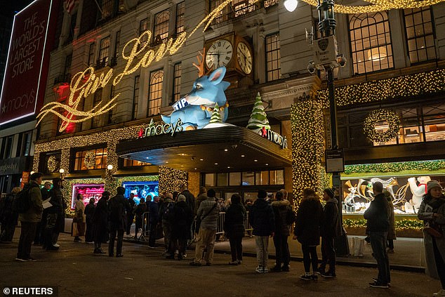 Shoppers wait before daylight Friday before entering Macy's department store in Manhattan