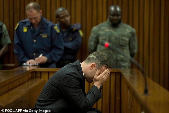 Pistorius covers his eyes as his late girlfriend's father testifies before the Pretoria High Court on June 14, 2016