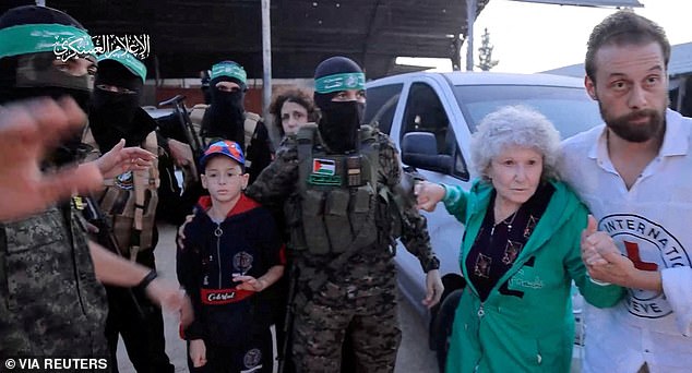 Hostages kidnapped by Hamas gunmen during the October 7 attack on Israel are handed over by Hamas militants to the International Red Cross