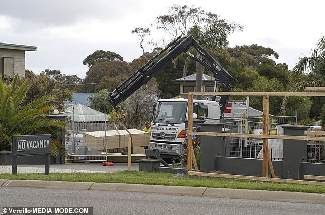 Just a short drive from Phillip Island's famous 'Penguin Parade', the former resort features palm trees and a sculpted garden.  Pictured: Workers preparing the site